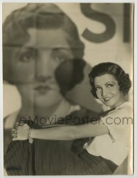 1s238 CLAUDETTE COLBERT 7x9.5 still '20s wonderful portrait in front of a 24-sheet from her movie!