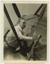 1s948 WALLACE BEERY 8x10.25 still '37 shining up the new Stinson monoplane he just bought!