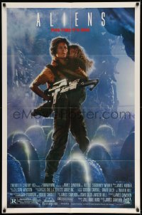 2b022 ALIENS 1sh '86 James Cameron, Sigourney Weaver as Ripley holding Carrie Henn!