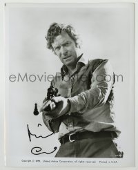 2j0588 MICHAEL CAINE signed 8x10.25 still '75 great close up with rifle from The Wilby Conspiracy!