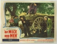 3c568 OF MICE & MEN LC '40 Meredith proves how strong Lon Chaney Jr. is by his lifting huge wagon!