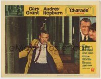 6c509 CHARADE LC #2 '63 great close up of Cary Grant running between stone pillars!