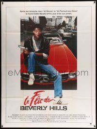 6p584 BEVERLY HILLS COP French 1p '84 great image of cop Eddie Murphy sitting on Mercedes!