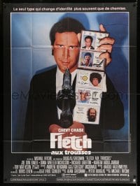 9f741 FLETCH French 1p 1985 wacky detective Chevy Chase showing fake ID cards at gunpoint!