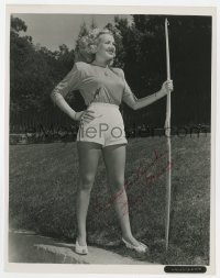 4t737 BETTY GRABLE signed 8x10 REPRO still 1970s full-length holding bow & arrow, showing her legs!