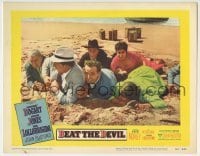 5b550 BEAT THE DEVIL LC #6 1953 Humphrey Bogart & cast members cowering & laying in sand on beach!