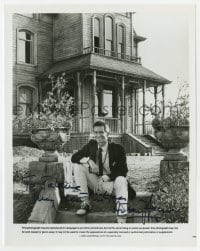 7s359 ANTHONY PERKINS signed 8x10.25 still 1985 candid portrait sitting by the Psycho III house!