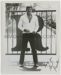 7s867 BURT REYNOLDS signed 8x10 REPRO still 1975 full-length posing by the gate of his home!