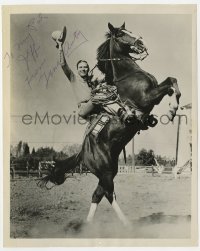 7s433 GENE AUTRY signed 8x10 still 1940s riding his rearing horse Champion with his hat in the air!
