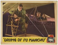 8d418 DRUMS OF FU MANCHU LC 1943 feature version, image of aviator lowering ladder from his airplane