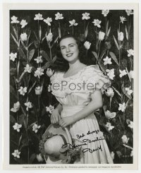 8y167 DEANNA DURBIN signed 8x10 still 1947 smiling in Easter dress with daffodils in background!