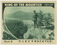 9b441 KING OF THE MOUNTIES chapter 8 LC 1942 Allan Rocky Lane standing on ledge, Electrocuted!