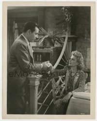 2a446 I STOLE A MILLION 8x10.25 still 1939 George Raft helping pretty seated Claire Trevor!