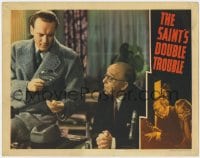 3b565 SAINT'S DOUBLE TROUBLE LC 1940 Ross watches George Sanders examining clue w/ magnifying glass!