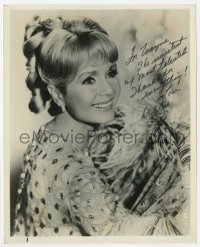 3d477 DEBBIE REYNOLDS signed 8x10 publicity still 1960s smiling portrait w/floral print & feathers!