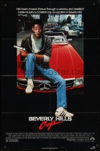 3j075 BEVERLY HILLS COP 1sh 1984 great image of detective Eddie Murphy sitting on red Mercedes!