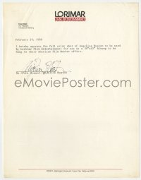 4x084 ANJELICA HUSTON signed letter 1988 letting Lorimar use a 30x40 blow up of her in office!