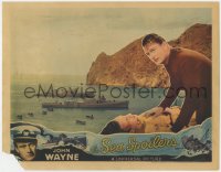 5m710 SEA SPOILERS LC 1936 c/u of John Wayne with man laying on ground by ships in harbor!