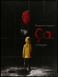 8b793 IT teaser French 1p 2017 creepy image of Pennywise handing child balloon from the shadows!