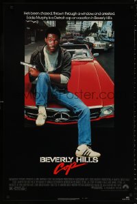 8k560 BEVERLY HILLS COP 1sh 1984 great image of detective Eddie Murphy sitting on red Mercedes!