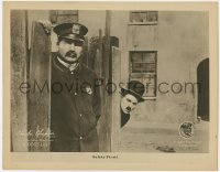 8z197 DOG'S LIFE LC 1918 Tramp Charlie Chaplin hiding behind fence sees policeman, safety first!