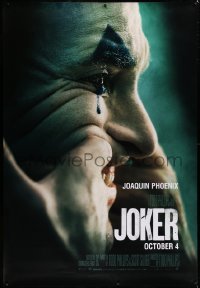 1d001 JOKER DS bus stop 2019 different image of clown Joaquin Phoenix putting on a happy face!