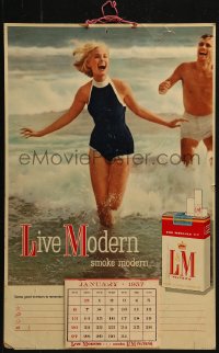 2z0026 L&M calendar 1957 Live Modern smoke modern, wacky image of happy couple on the beach!