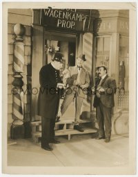 3r0489 RICHEST MAN IN THE WORLD 8x10.25 still 1930 policeman interrogates two men outside shop!