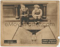 3z0563 BEHIND THE SCREEN LC R1922 Purviance watches Charlie Chaplin laughing at Goliath trapped!