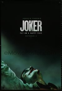 4j0934 JOKER teaser DS 1sh 2019 close-up image of clown Joaquin Phoenix, put on a happy face!
