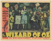 7a0481 WIZARD OF OZ LC 1939 Judy Garland with Munchkins & coroner, The Wicked Witch is dead, rare!