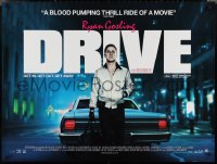 3g0130 DRIVE British quad 2011 Ryan Gosling behind car w/bag, directed by Nicolas Winding Refn!