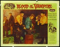 2n090 BLOOD OF THE VAMPIRE lobby card #7 '58 Vincent Ball has handcuffs put on him by blacksmith!