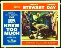 3b486 MAN WHO KNEW TOO MUCH LC #2 '56 Hitchcock, James Stewart picking up knife by stabbed man!