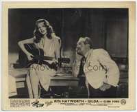 3m142 GILDA English FOH lobby card '46 sexiest Rita Hayworth sitting on desk playing guitar!