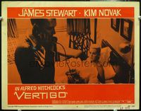 4c922 VERTIGO LC #5 '58 Alfred Hitchcock, standing James Stewart on phone, blonde Kim Novak in bed!
