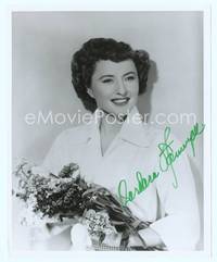 7f018 BARBARA STANWYCK signed 8x10 still '70s standing & holding a bouquet of flowers!