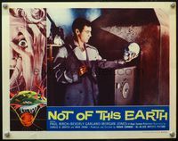 7r581 NOT OF THIS EARTH LC '57 Roger Corman classic, close up of man examining skull!