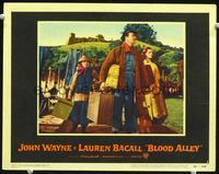 8j086 BLOOD ALLEY LC #3 '55 John Wayne carrying Lauren Bacall's luggage, arriving in China!