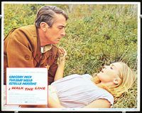 8j393 I WALK THE LINE LC #2 '70 c/u of Gregory Peck with Tuesday Weld in grass, John Frankenheimer