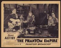 1z486 PHANTOM EMPIRE Chap4 LC '35 wonderful image of cowboy Gene Autry playing guitar on the radio!