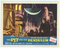 3a331 PIT & THE PENDULUM LC #8 '61 close up of Vincent Price by man on table under giant blade!