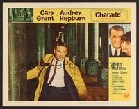 3d319 CHARADE LC #2 '63 great close up of Cary Grant running between stone pillars!