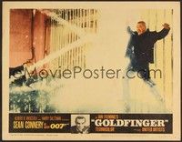 3d389 GOLDFINGER LC #3 '64 Sean Connery as Bond watches Harold Oddjob Sakata get electrocuted!