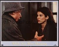 3d688 WHILE YOU WERE SLEEPING LC '95 close up of Jack Warden looking at pretty Sandra Bullock!