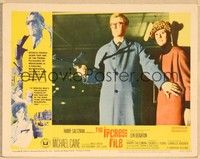 4k331 IPCRESS FILE LC #1 '65 pretty Sue Lloyd stands behind spy Michael Caine with gun!