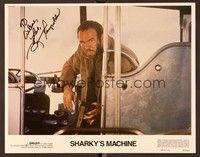 5g071 SHARKY'S MACHINE signed LC #1 '81 by Burt Reynolds, who's close up with gun in front of bus!