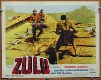 5z616 ZULU LC #7 '64 close up of English soldier Michael Caine face to face with Zulu on rooftop!