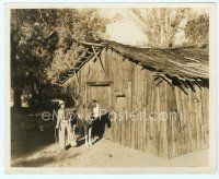 6a202 GARY COOPER 8x10 still '20s standing with horse by falling down cabin by Don English