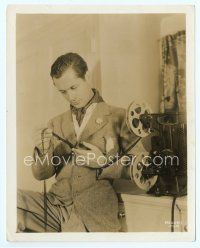 6a484 ROBERT MONTGOMERY candid 8x10 still '30s studying the film from his home projector!